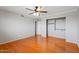 Spacious bedroom featuring hardwood floors and a ceiling fan at 2024 N 125Th Ave, Avondale, AZ 85392