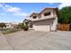 Two-story home with desert landscaping, and a two-car garage at 2024 N 125Th Ave, Avondale, AZ 85392