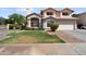 Two-story home featuring a two-car garage and desert landscaping at 2024 N 125Th Ave, Avondale, AZ 85392