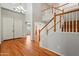Spacious foyer featuring hardwood floors, staircase, and double doors at 2024 N 125Th Ave, Avondale, AZ 85392