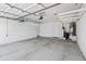 Spacious garage with high ceilings, overhead storage racks and painted concrete floors at 2024 N 125Th Ave, Avondale, AZ 85392