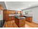 Bright kitchen with a large island, wooden cabinets and stainless-steel appliances at 2024 N 125Th Ave, Avondale, AZ 85392