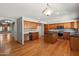 Bright kitchen featuring an island, tile backsplash, and hardwood floors at 2024 N 125Th Ave, Avondale, AZ 85392