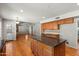 Open kitchen featuring hardwood floors and a center island at 2024 N 125Th Ave, Avondale, AZ 85392