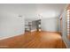 Open-concept living area with hardwood floors and neutral paint colors at 2024 N 125Th Ave, Avondale, AZ 85392