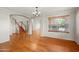 Open living space featuring hardwood floors, staircase, and bright light at 2024 N 125Th Ave, Avondale, AZ 85392