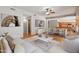 Bright open-concept living room with modern furnishings, hardwood floors and eat-in kitchen island at 2024 N 125Th Ave, Avondale, AZ 85392