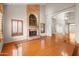 Bright living room showcasing a fireplace, hardwood floors, and natural light at 2024 N 125Th Ave, Avondale, AZ 85392