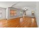 Spacious living room with hardwood floors, a ceiling fan, and natural light through multiple windows at 2024 N 125Th Ave, Avondale, AZ 85392