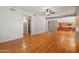 Spacious living room with hardwood floors open to the kitchen with wooden cabinets at 2024 N 125Th Ave, Avondale, AZ 85392