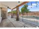 Covered patio with stone pillars and a wrought iron fence surrounding the pool area at 2024 N 125Th Ave, Avondale, AZ 85392