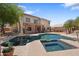 Backyard with a spacious pool and spa, large patio, and a two-story home at 2024 N 125Th Ave, Avondale, AZ 85392