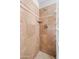 Shower with a glass block wall, tiled wall and floor, a shower head and a small shelf at 2024 N 125Th Ave, Avondale, AZ 85392