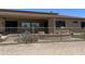 Spacious backyard with desert landscaping, wrought iron fence, and covered outdoor patio area at 20332 N Denizen Dr, Surprise, AZ 85387
