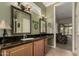 Bathroom featuring granite countertops with a sink, a large mirror, and access to the living room at 20332 N Denizen Dr, Surprise, AZ 85387