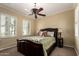Bedroom featuring a leather headboard, ceiling fan, and shuttered windows allowing natural light at 20332 N Denizen Dr, Surprise, AZ 85387