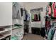 Walk-in closet with custom shelving, ample storage, and hanging clothes at 20332 N Denizen Dr, Surprise, AZ 85387