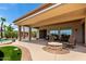 Covered patio with comfortable seating and fire pit, perfect for outdoor relaxation at 20332 N Denizen Dr, Surprise, AZ 85387