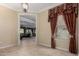 Inviting dining area featuring tiled floors and large window with decorative valance at 20332 N Denizen Dr, Surprise, AZ 85387