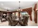 Formal dining area with a grand chandelier, table seating, and sliding glass doors at 20332 N Denizen Dr, Surprise, AZ 85387