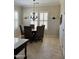 A dining room with seating for six features neutral walls, window shutters, and a chandelier at 20332 N Denizen Dr, Surprise, AZ 85387