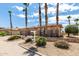Street view of a well-maintained, tan single-story home framed by tall palm trees at 20332 N Denizen Dr, Surprise, AZ 85387