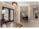 Inviting foyer with decorative tile flooring and elegant wrought iron front door at 20332 N Denizen Dr, Surprise, AZ 85387