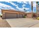 Spacious three-car garage and front exterior of a well maintained desert home at 20332 N Denizen Dr, Surprise, AZ 85387