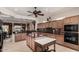 Well lit kitchen featuring tile floor, wood cabinets and dark countertops at 20332 N Denizen Dr, Surprise, AZ 85387