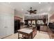 Spacious kitchen with tile floors, wood cabinets, black appliances, and adjacent breakfast bar at 20332 N Denizen Dr, Surprise, AZ 85387