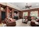 Comfortable living room features built-in shelving, a fireplace, and ample seating at 20332 N Denizen Dr, Surprise, AZ 85387