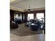A living room featuring built-in shelving, a fireplace, recessed lighting, and large windows at 20332 N Denizen Dr, Surprise, AZ 85387