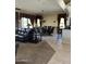 Spacious open-concept living area with tile flooring and large windows bringing in natural light at 20332 N Denizen Dr, Surprise, AZ 85387