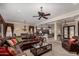 Open-concept living room with a cozy sectional couch flowing into the kitchen at 20332 N Denizen Dr, Surprise, AZ 85387