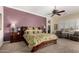 Spacious bedroom with a ceiling fan, bedside tables and a comfortable seating area at 20332 N Denizen Dr, Surprise, AZ 85387