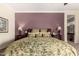 Main bedroom with floral bedspread, decorative lamps and adjacent vanity area at 20332 N Denizen Dr, Surprise, AZ 85387