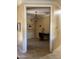 This tan home office features a tile floor, beige walls, chandelier, and a desk against the back wall at 20332 N Denizen Dr, Surprise, AZ 85387