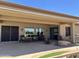 Relaxing covered patio with outdoor furniture and built-in fire pit and grill at 20332 N Denizen Dr, Surprise, AZ 85387