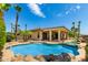 Beautiful backyard with a sparkling pool and spa, lush landscaping, and a covered patio for outdoor enjoyment at 20332 N Denizen Dr, Surprise, AZ 85387