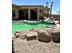 Refreshing pool with rock features, spa, and covered patio in the backyard at 20332 N Denizen Dr, Surprise, AZ 85387