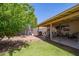 Covered backyard patio with ample seating, barbecue grill, and a fire pit on a sunny day at 2202 S Lawther Dr, Apache Junction, AZ 85120