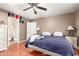 Spacious bedroom with hardwood floors, ceiling fan, two dressers and neutral wall paint at 2202 S Lawther Dr, Apache Junction, AZ 85120