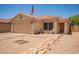 Inviting single-story home with desert landscaping and a cozy front patio seating area at 2202 S Lawther Dr, Apache Junction, AZ 85120