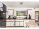 Well-lit kitchen with white cabinetry, and a window for natural light, perfect for culinary adventures at 2202 S Lawther Dr, Apache Junction, AZ 85120