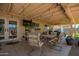 Covered patio with comfortable seating, a TV, and string lights, perfect for outdoor relaxation and entertaining at 2202 S Lawther Dr, Apache Junction, AZ 85120