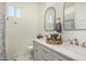 This is a well-lit double vanity bathroom with elegant fixtures at 22414 W Meade Ln, Buckeye, AZ 85326