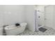 Bright bathroom showcases a soaking tub, tiled walls, and patterned floor at 22414 W Meade Ln, Buckeye, AZ 85326