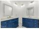 Bright bathroom features double sinks, framed mirrors, and decorative tile flooring at 22414 W Meade Ln, Buckeye, AZ 85326