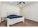 Simple bedroom showcasing a large bed with white frame and ceiling fan for optimal comfort at 22414 W Meade Ln, Buckeye, AZ 85326