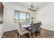 Cozy dining area features a rustic wood table, comfortable seating, and a charming window view at 22414 W Meade Ln, Buckeye, AZ 85326